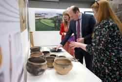 Communities Minister Lyons looks at some of the HERoNI artifacts on exhibition at PRONI