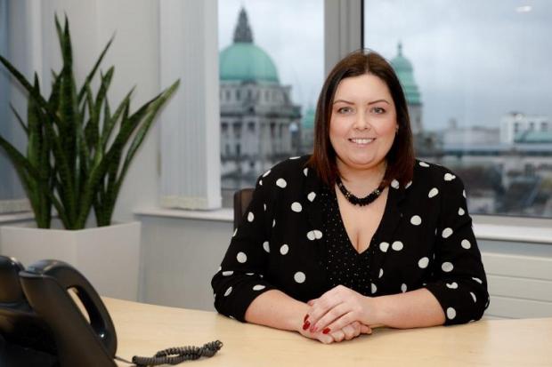 Minister Hargey pictured at her desk in Causeway Exchange