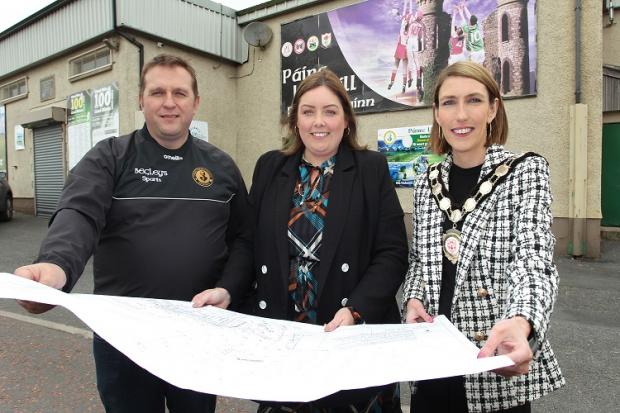 Communities Minister Deirdre Hargey is pictured at Thomas Clarkes GFC Dungannon with Thomas Clarkes GFC Chair John McNulty and Chair of Mid Ulster District Council Councillor Córa Corry