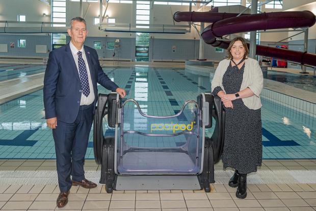 Communities Minister Deirdre Hargey and Agriculture, Environment and Rural Affairs Minister Edwin Poots at Greenvale Leisure Centre in Magherafelt to launch this year's Access and Inclusion Programme. The Ministers are pictured by a Pool Pod hoist system 