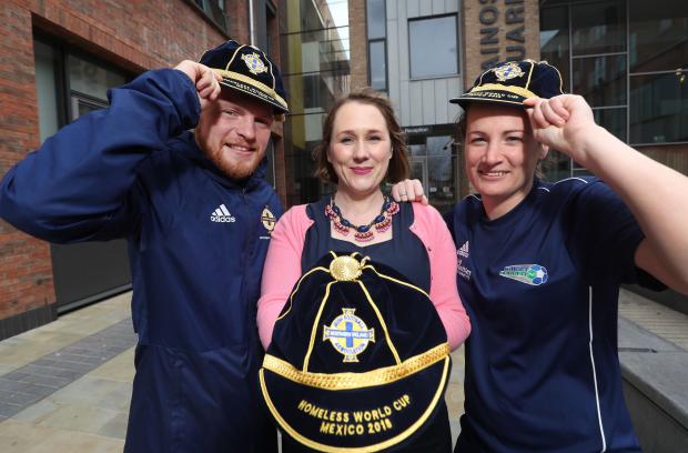 Moira Doherty and two members of the Northern Ireland homeless world cup squad show off caps presented to each member of the squad