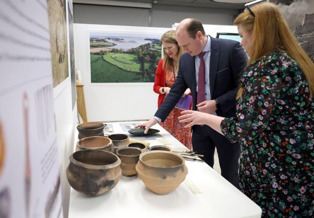 Communities Minister Lyons looks at some of the HERoNI artifacts on exhibition at PRONI