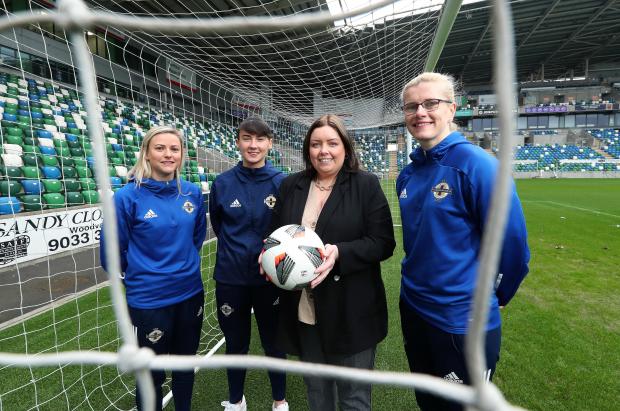 Communities Minister Deirdre Hargey is pictured with footballers Nadene Caldwell, Toni Leigh Finnegan and Julie Nelson