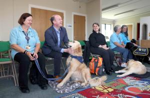 Communities Minister Gordon Lyons chats with Linda and her ambassador dog Parker at Carrickfergus Castle where Departmental officials have been working with Guide Dogs to make our monuments more accessible.