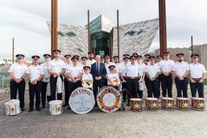 Communities Minister Gordon Lyons pictured with the Loyal Flute Band and the Imperial Guards Flute Band at the Fleadh who were awarded support from the Musical Instruments Programme
