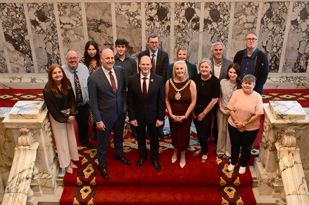 Lord Mayor of Belfast, Councillor Tracy Kelly; MLA Minister Gordon Lyons; the US Consul General Belfast, James Applegate, Head of the Northern Ireland Civil Service; Jayne Brady, and PRONI Staff pictured on the Central Staircase in Belfast City Hall